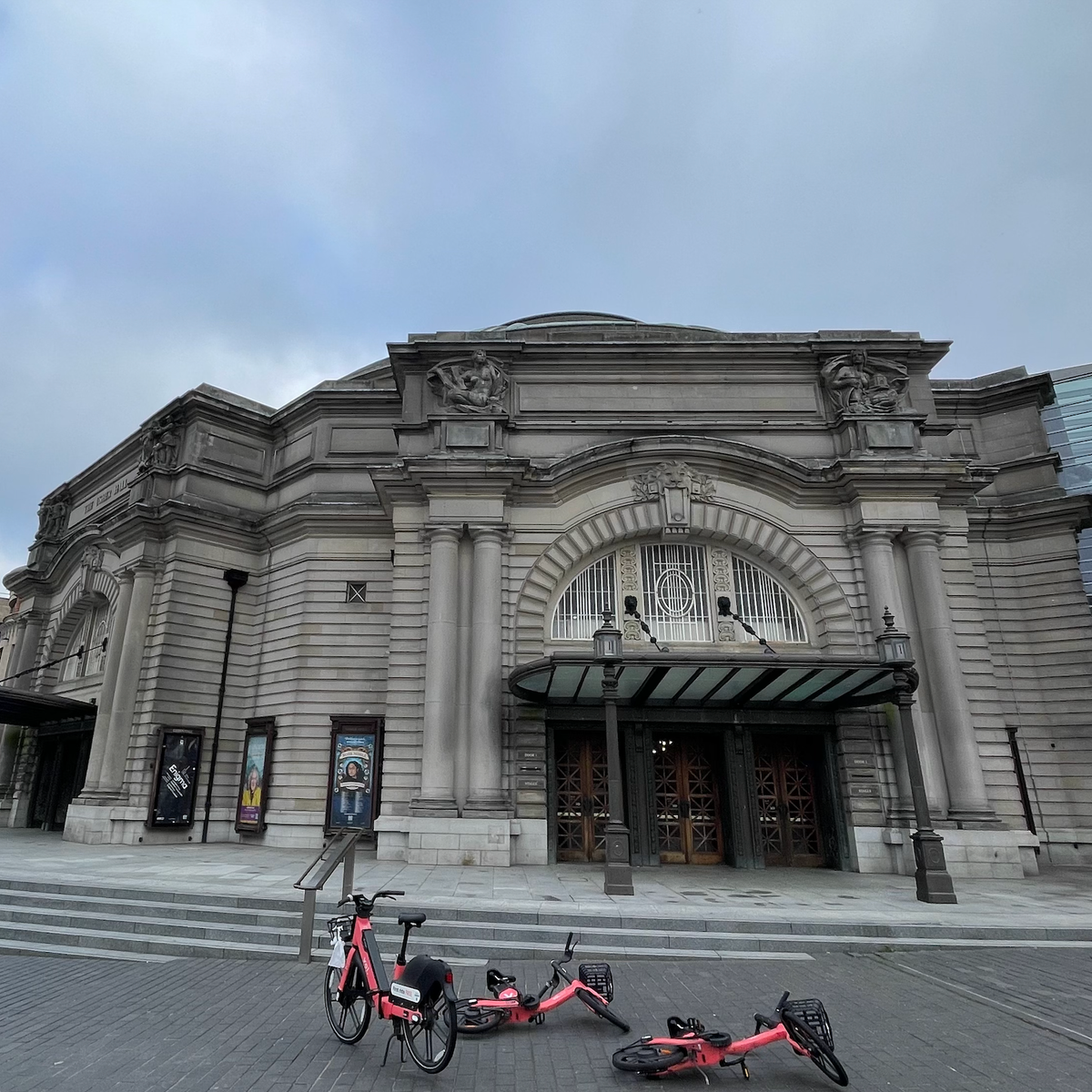 Three red bikes outside the Usher Hall music venue. 