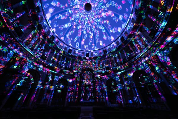 Multi-coloured lights on the ceiling and walls of a large room. 